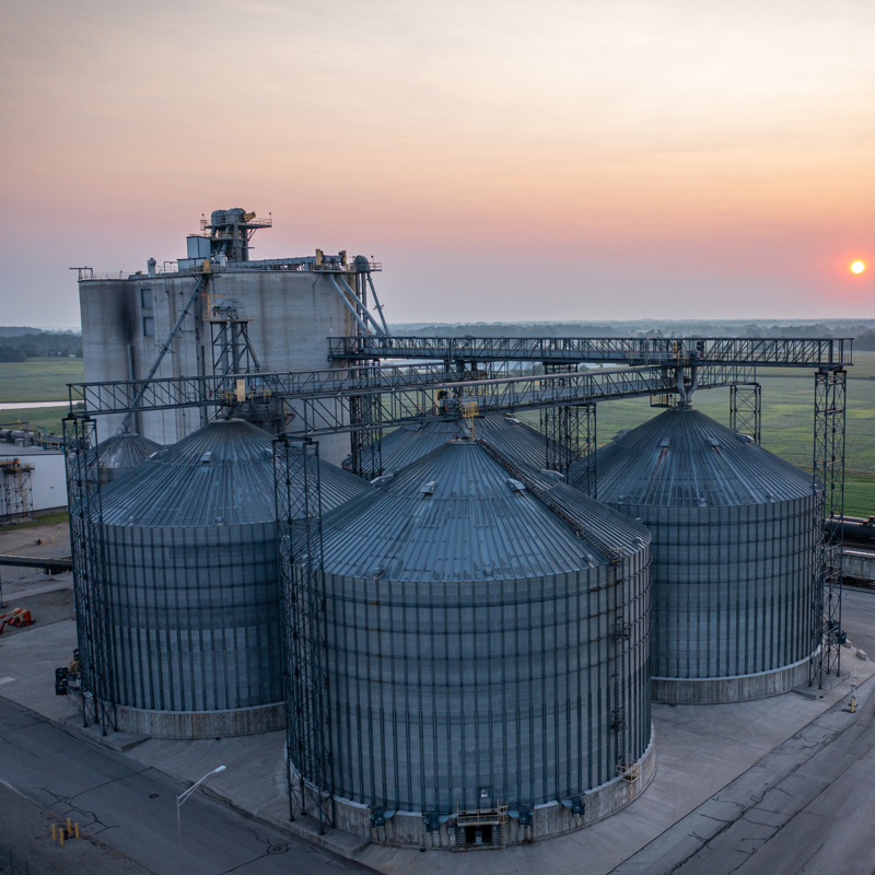 Grain bins with sunset in background