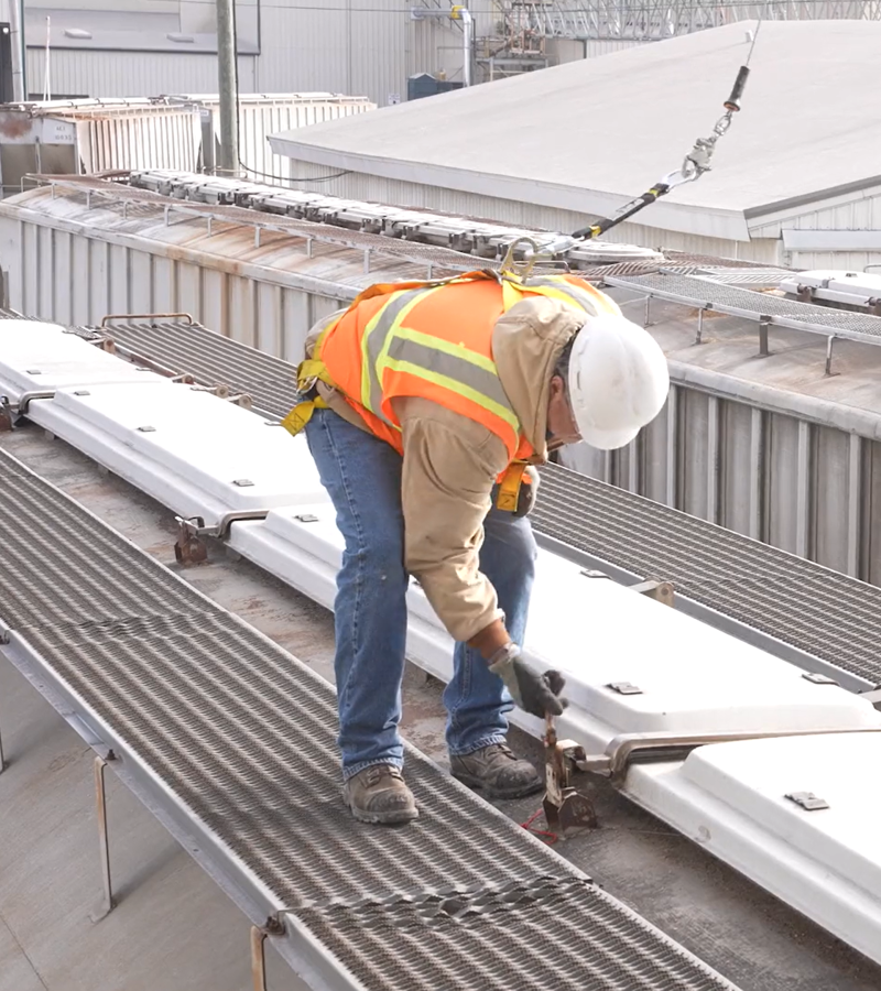 Employee in harness on railcar